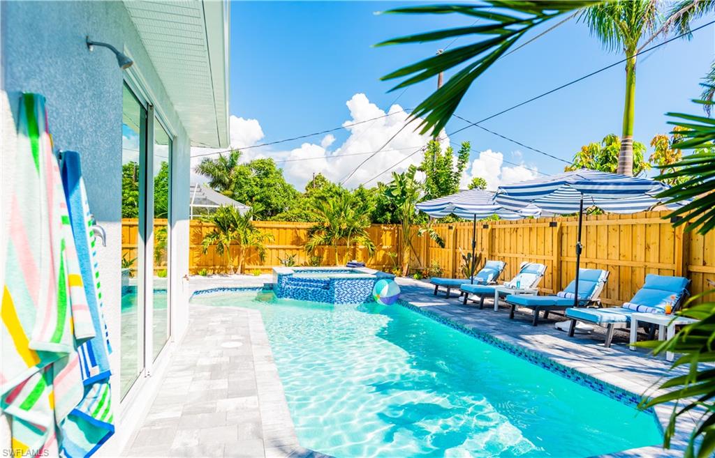 a view of a swimming pool with chairs in patio