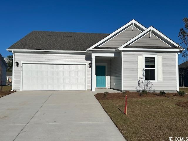 View of front of property featuring a garage and a