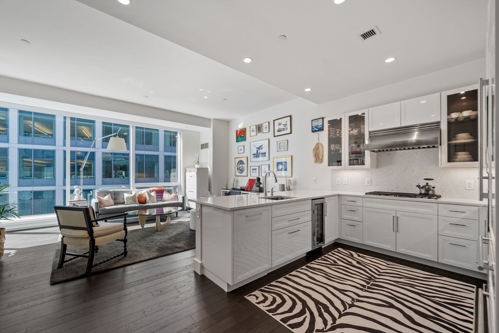 a kitchen with sink cabinets and wooden floor