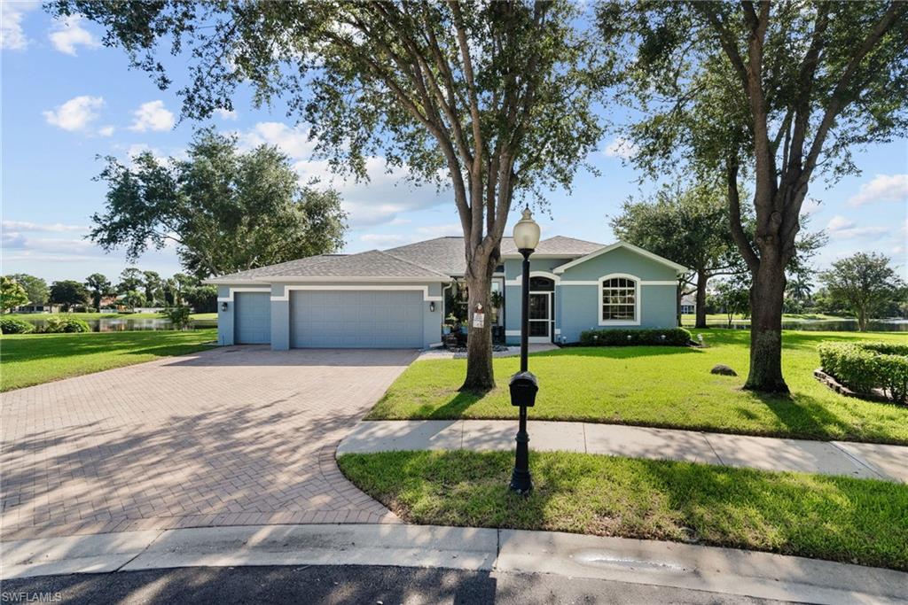 a front view of house with yard and green space