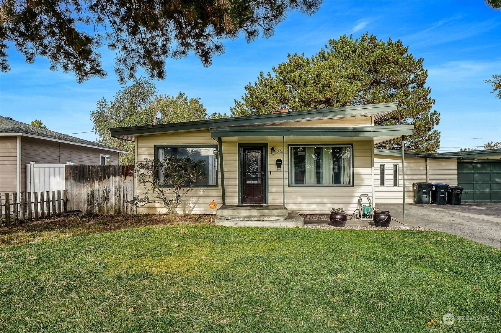 a front view of a house with a yard and porch