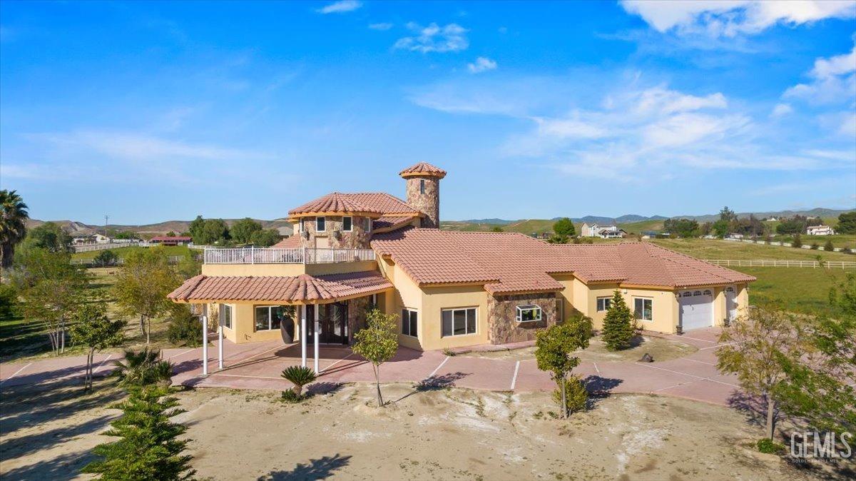 an aerial view of a house with a yard and lake view