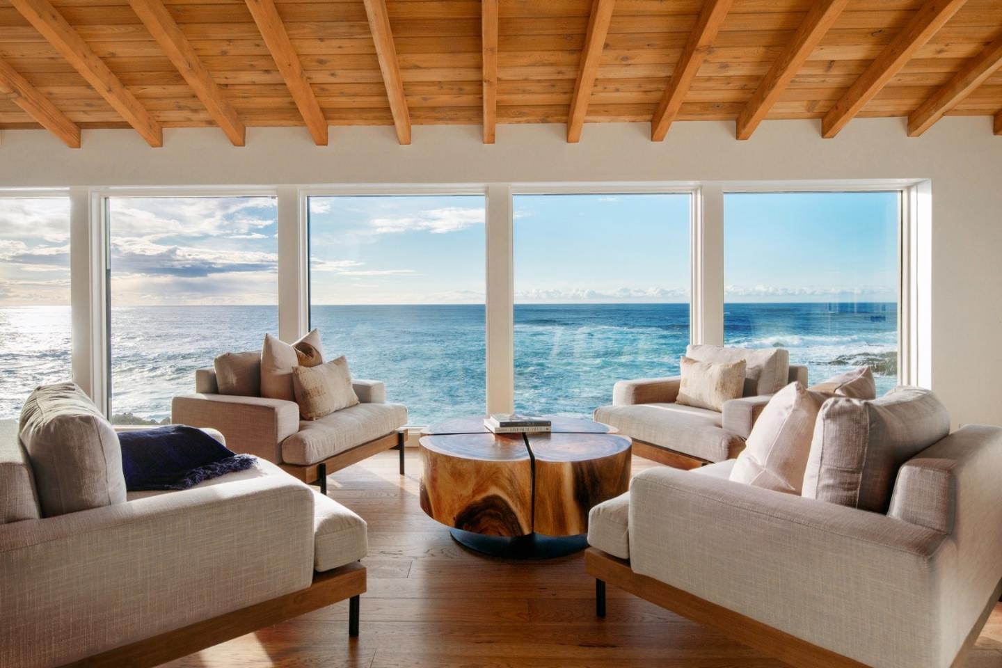 a living room with furniture and floor to ceiling windows