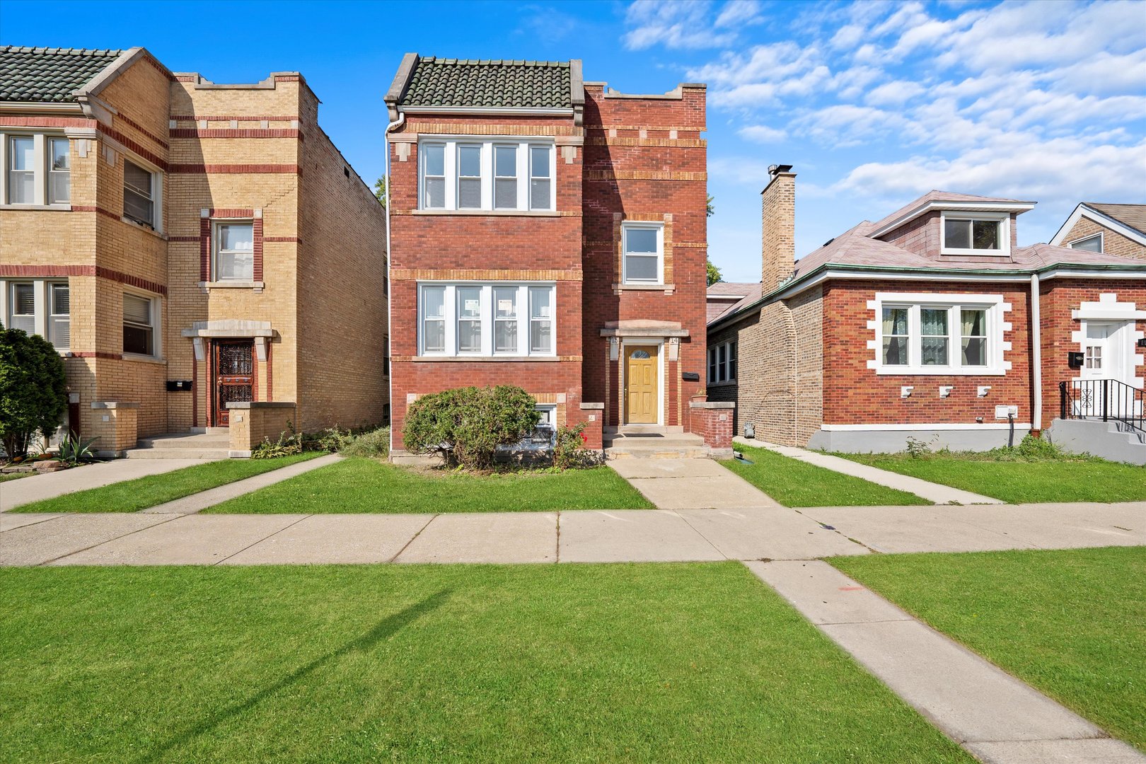 a view of a brick building next to a yard