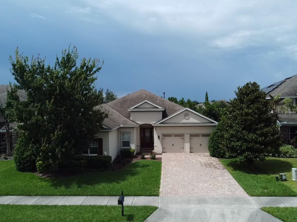 a front view of a house with a garden and yard