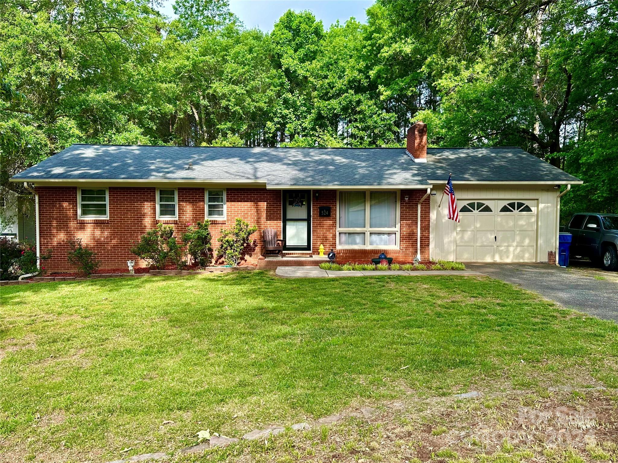 a front view of house with yard and green space