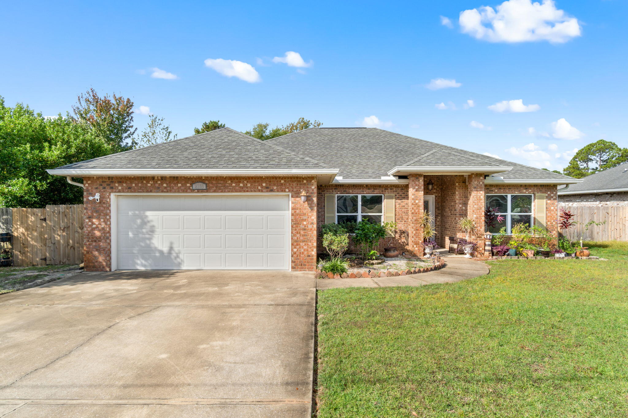 a front view of a house with patio and garden