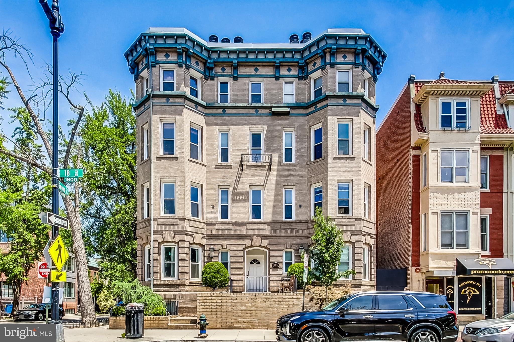 a front view of a building and car parked