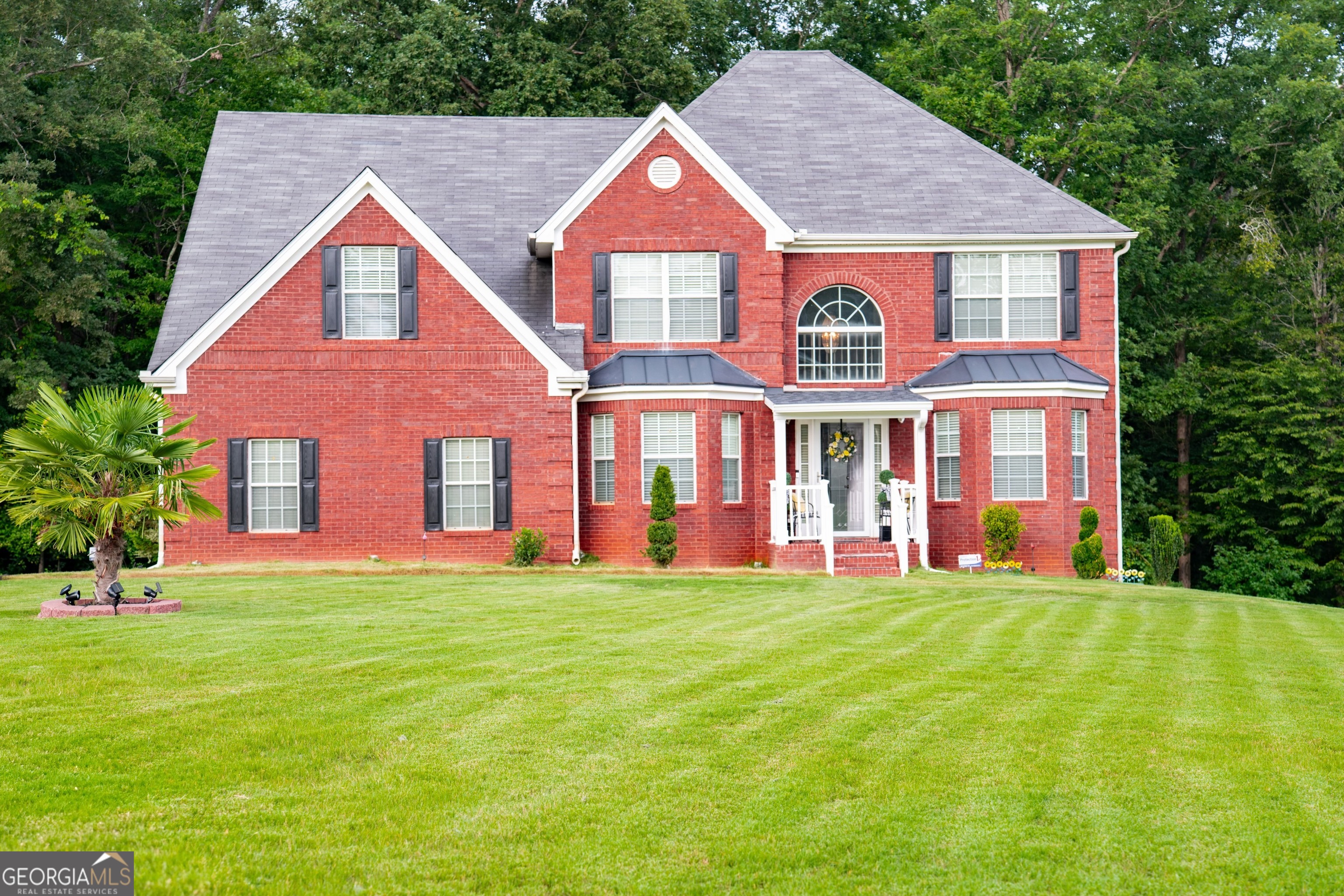 a front view of houses with yard