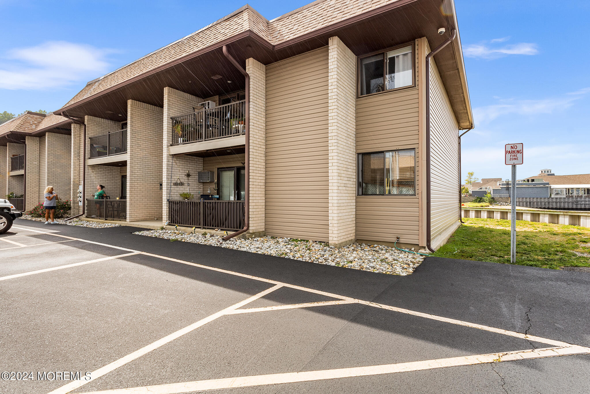 a view of a house with a large parking space and two windows