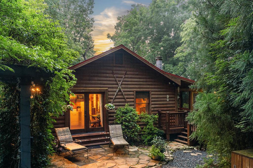 a front view of house with trees around