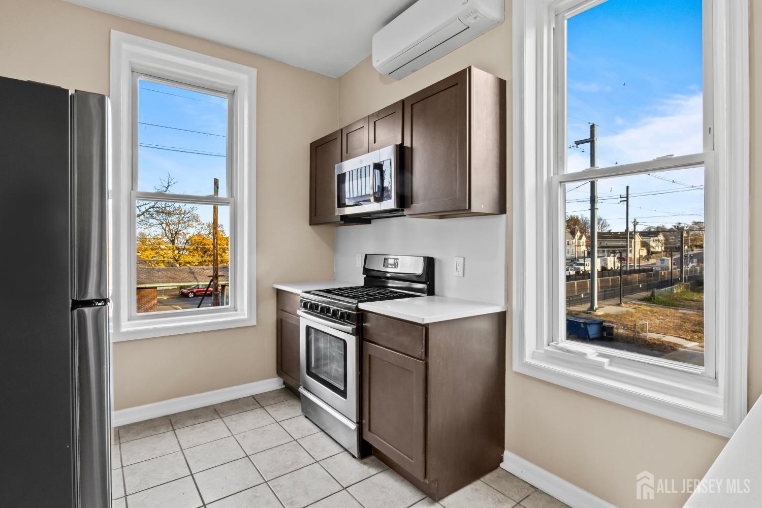 a kitchen with stainless steel appliances granite countertop a stove a sink and a refrigerator