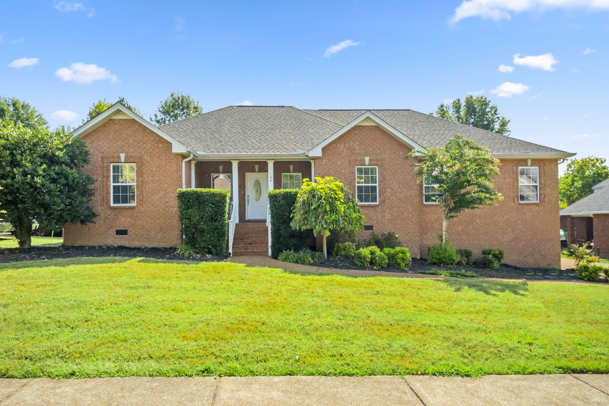 a front view of a house with a yard