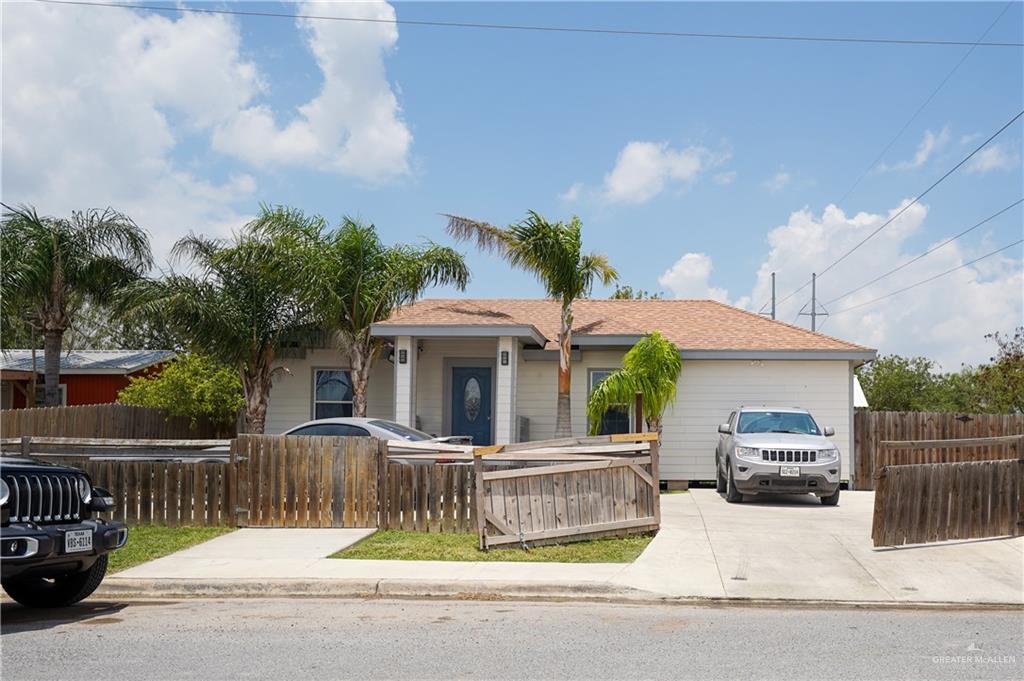 a front view of a house with a garden and plants