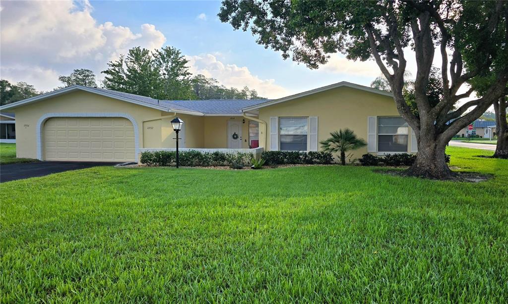 a front view of house with yard and green space