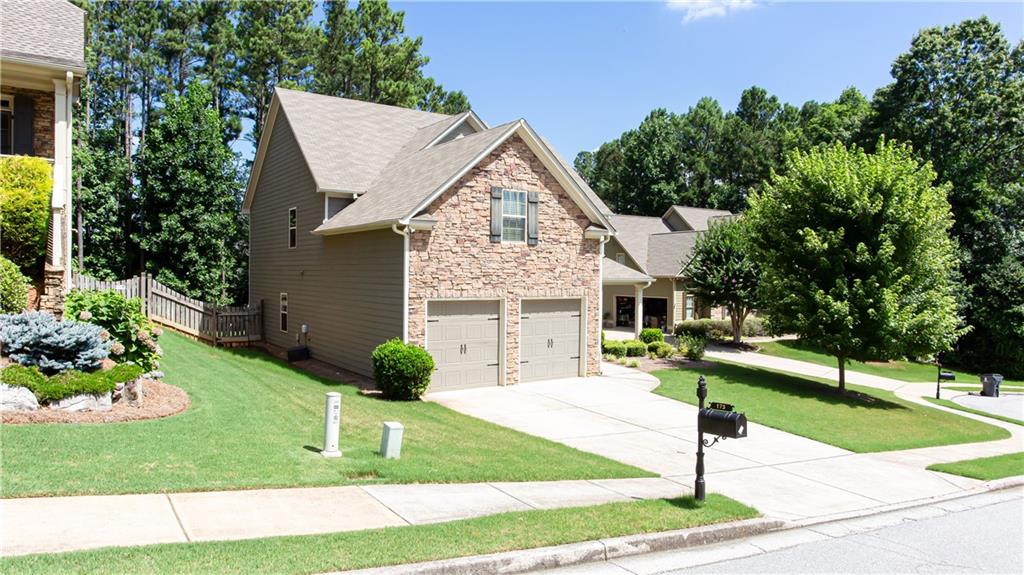 a front view of a house with a yard and garage