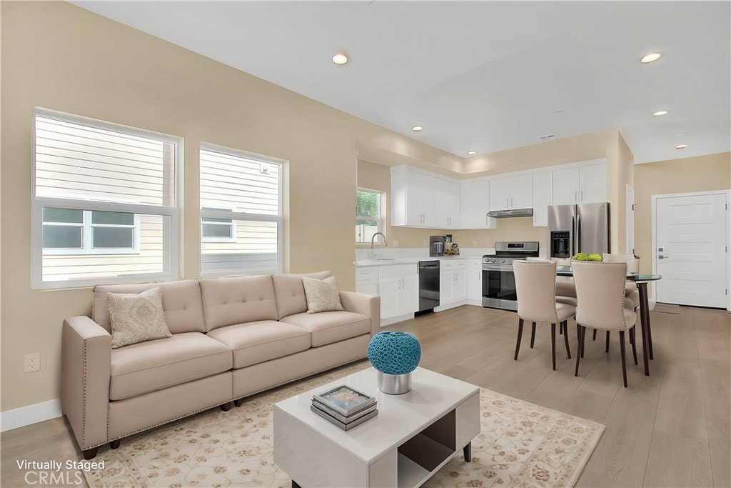 a living room with furniture and kitchen view