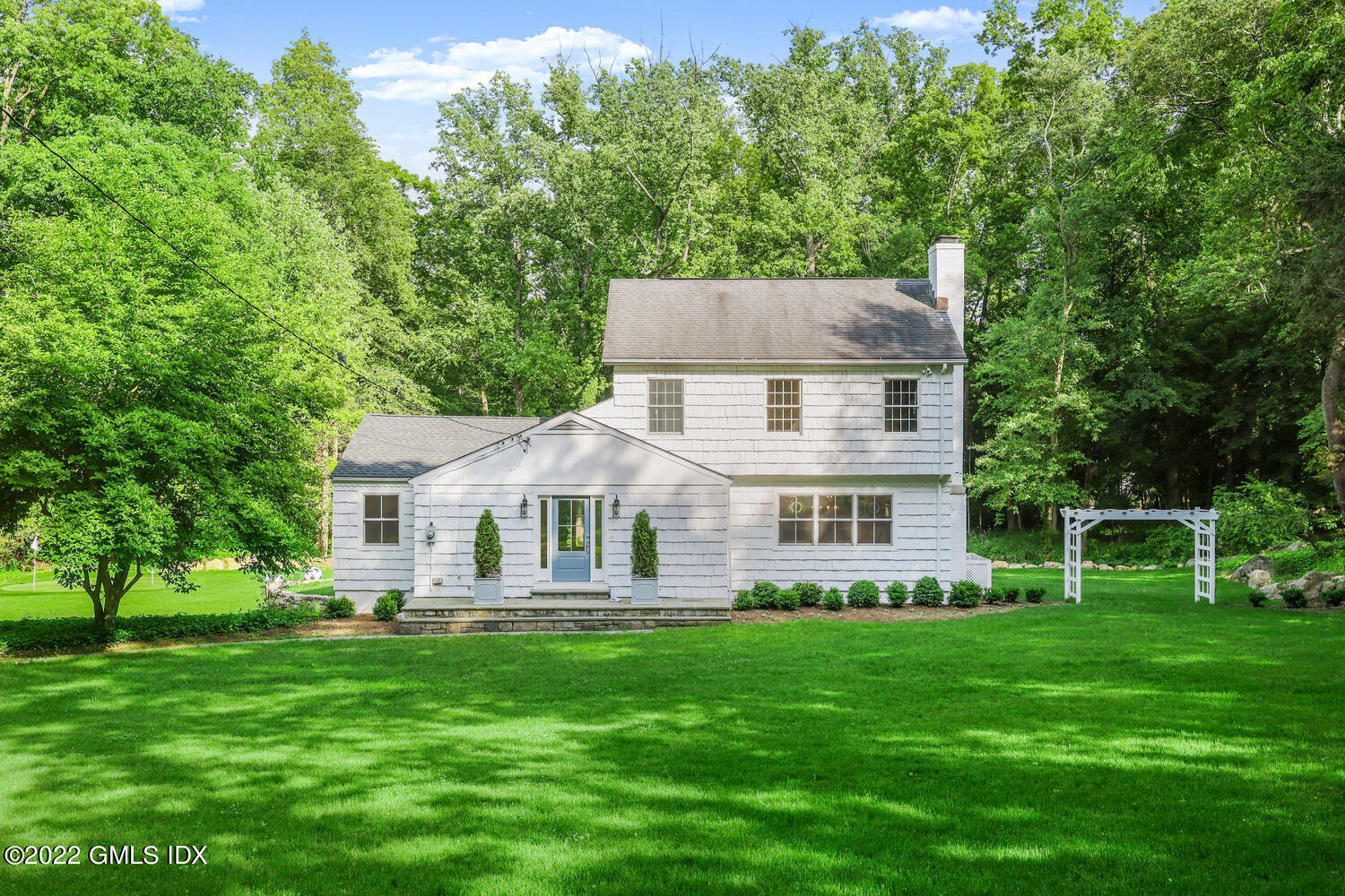 a front view of a house with a yard table and chairs