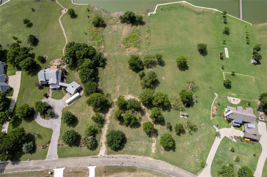 an aerial view of a residential houses with yard