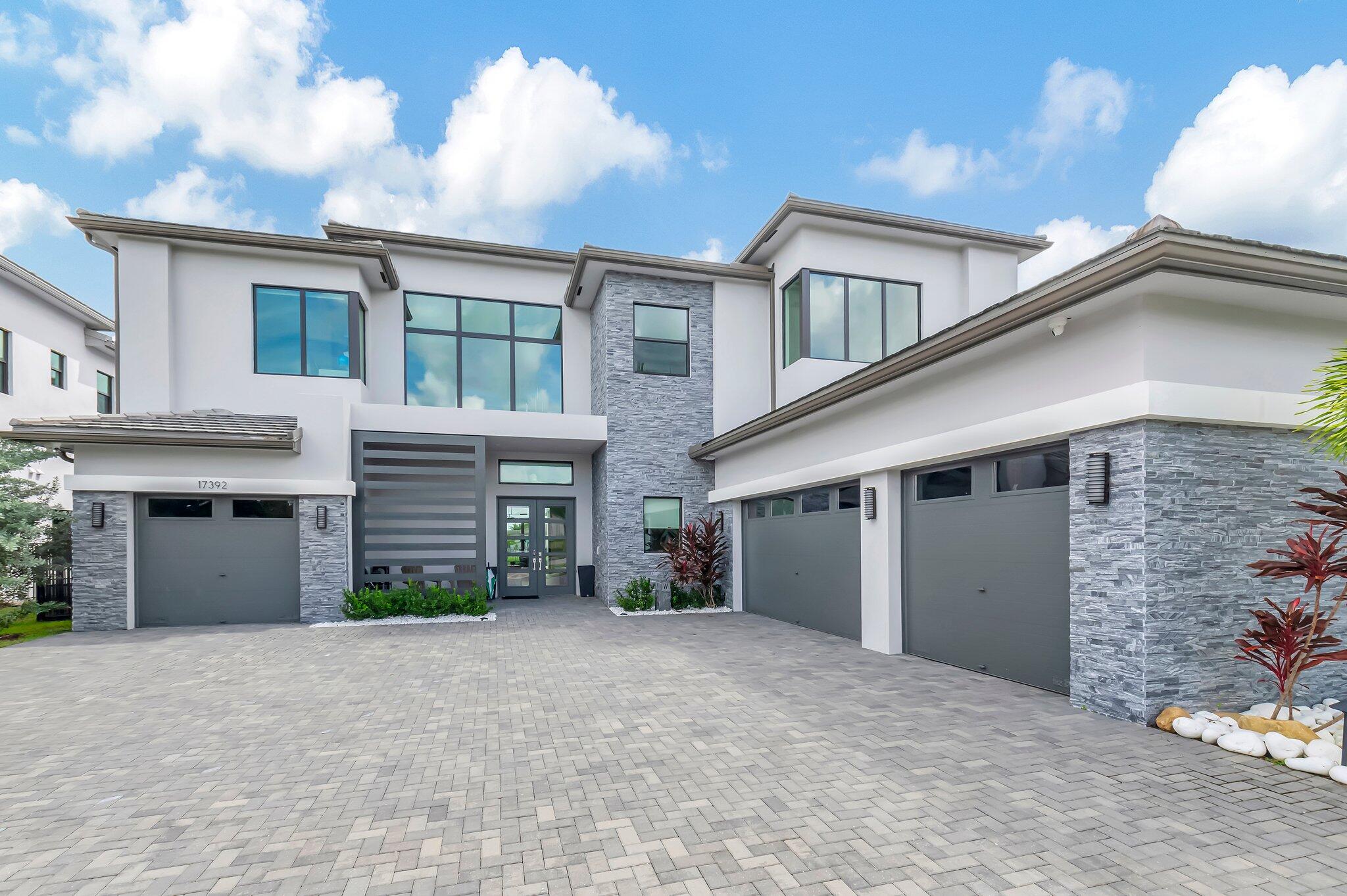 a view of a house with a yard and garage