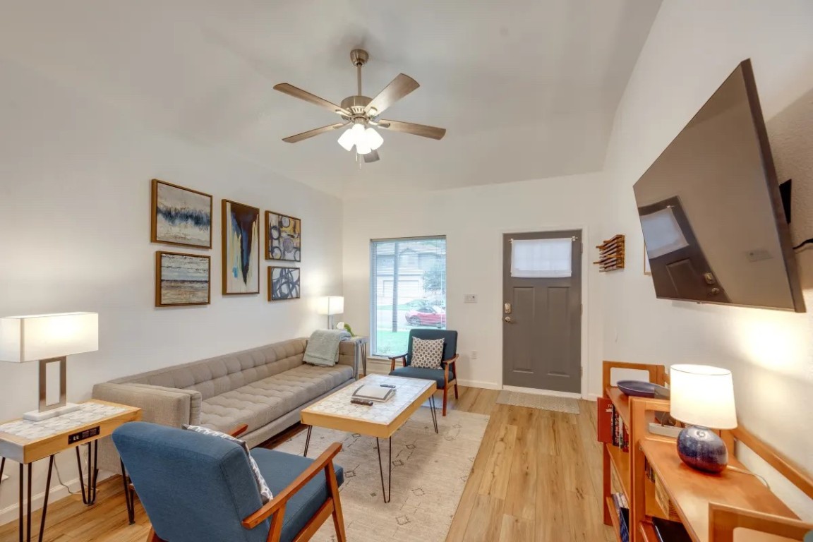 a living room with furniture a rug and a lamp