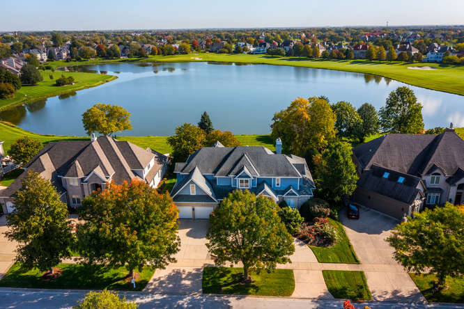 an aerial view of a house with a swimming pool yard and outdoor seating