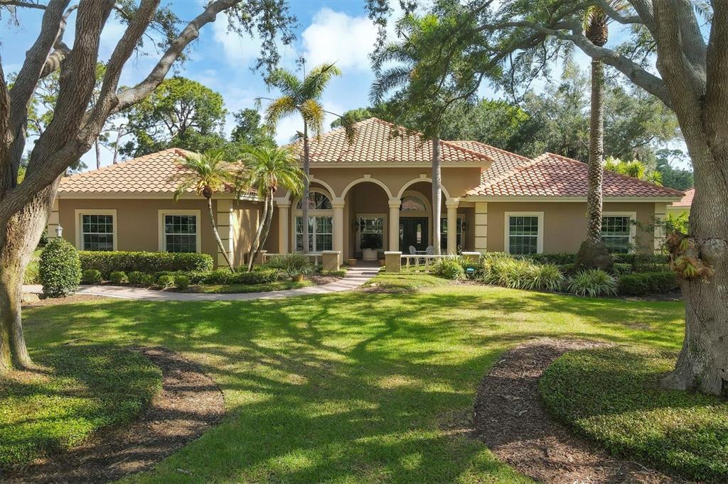 a front view of a house with a garden