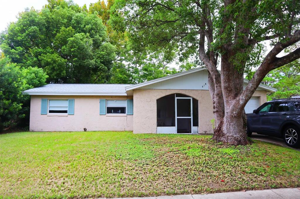 a front view of house with yard and trees