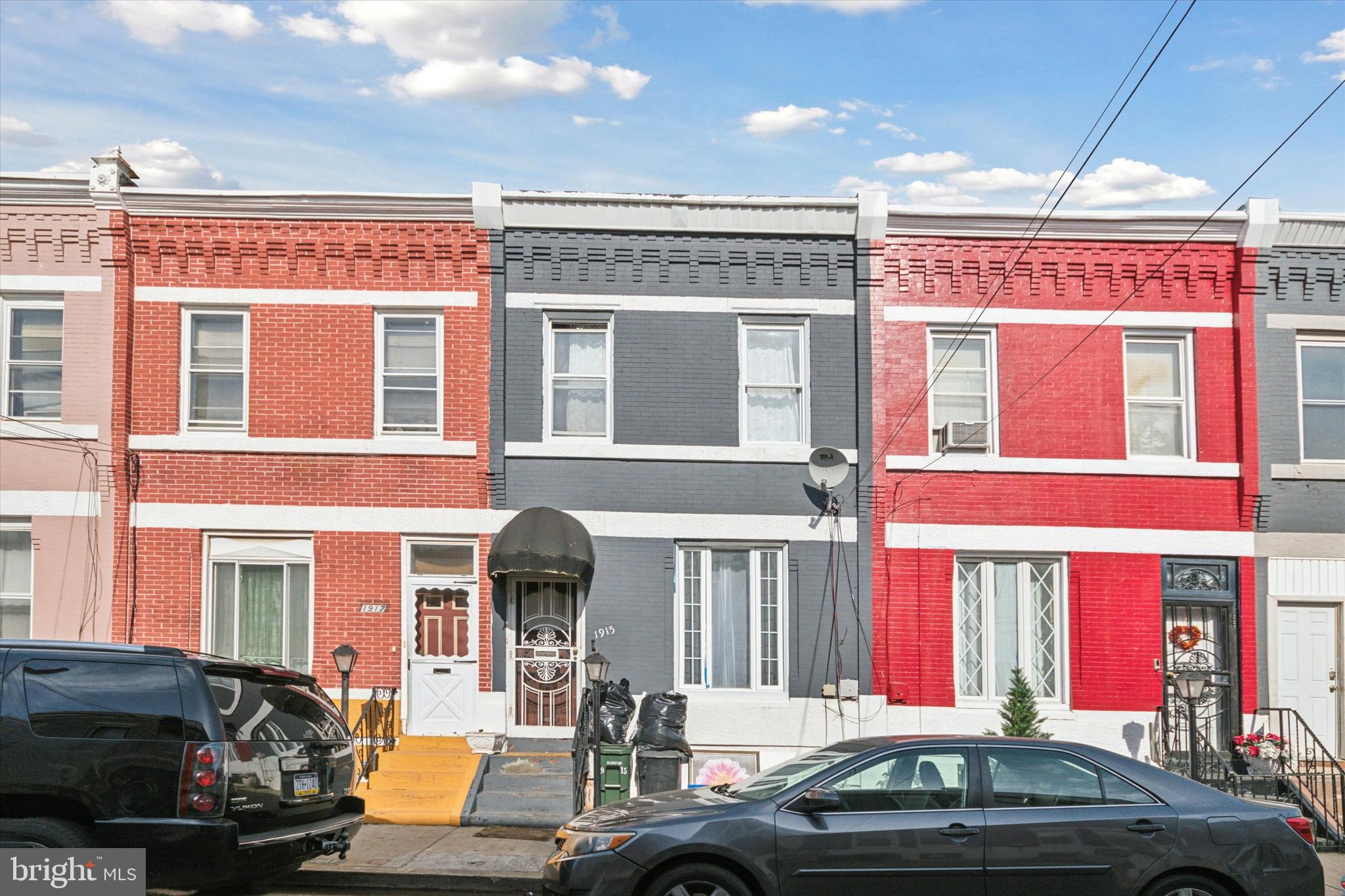 a front view of a building with car parked