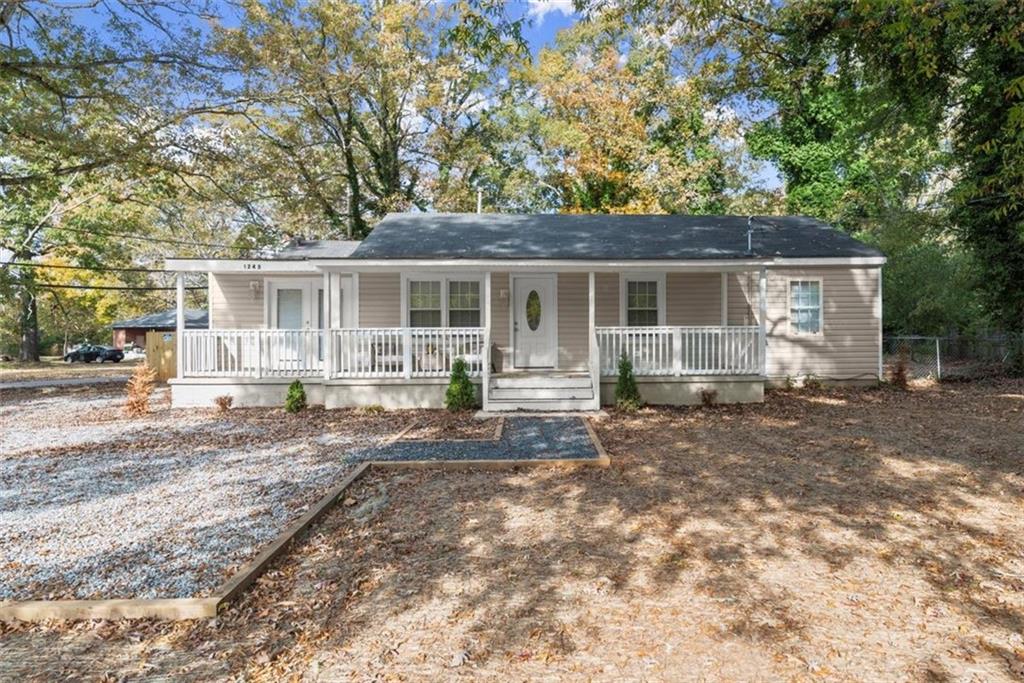 a view of a house with backyard and chairs