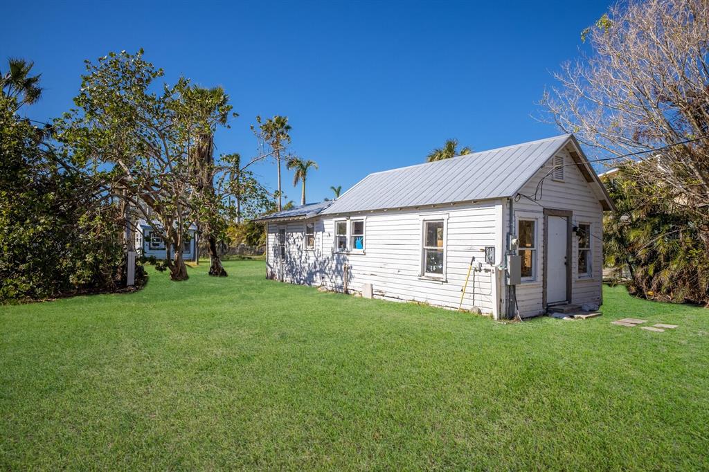 a view of a house with a yard and sitting area