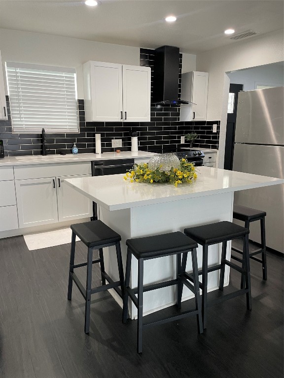 a kitchen with stainless steel appliances kitchen island granite countertop a table chairs sink and cabinets