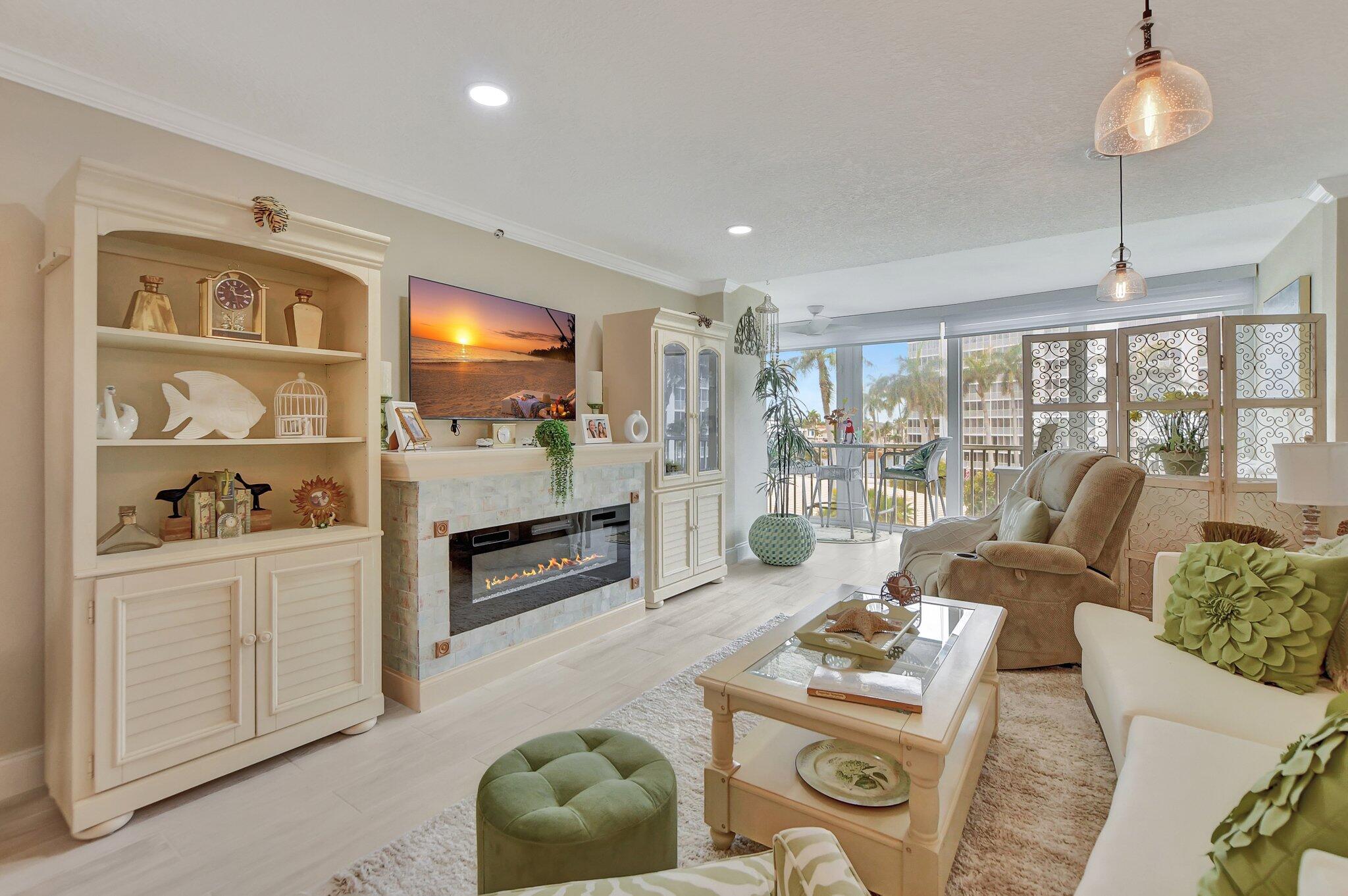 a living room with furniture a flat screen tv and a floor to ceiling window