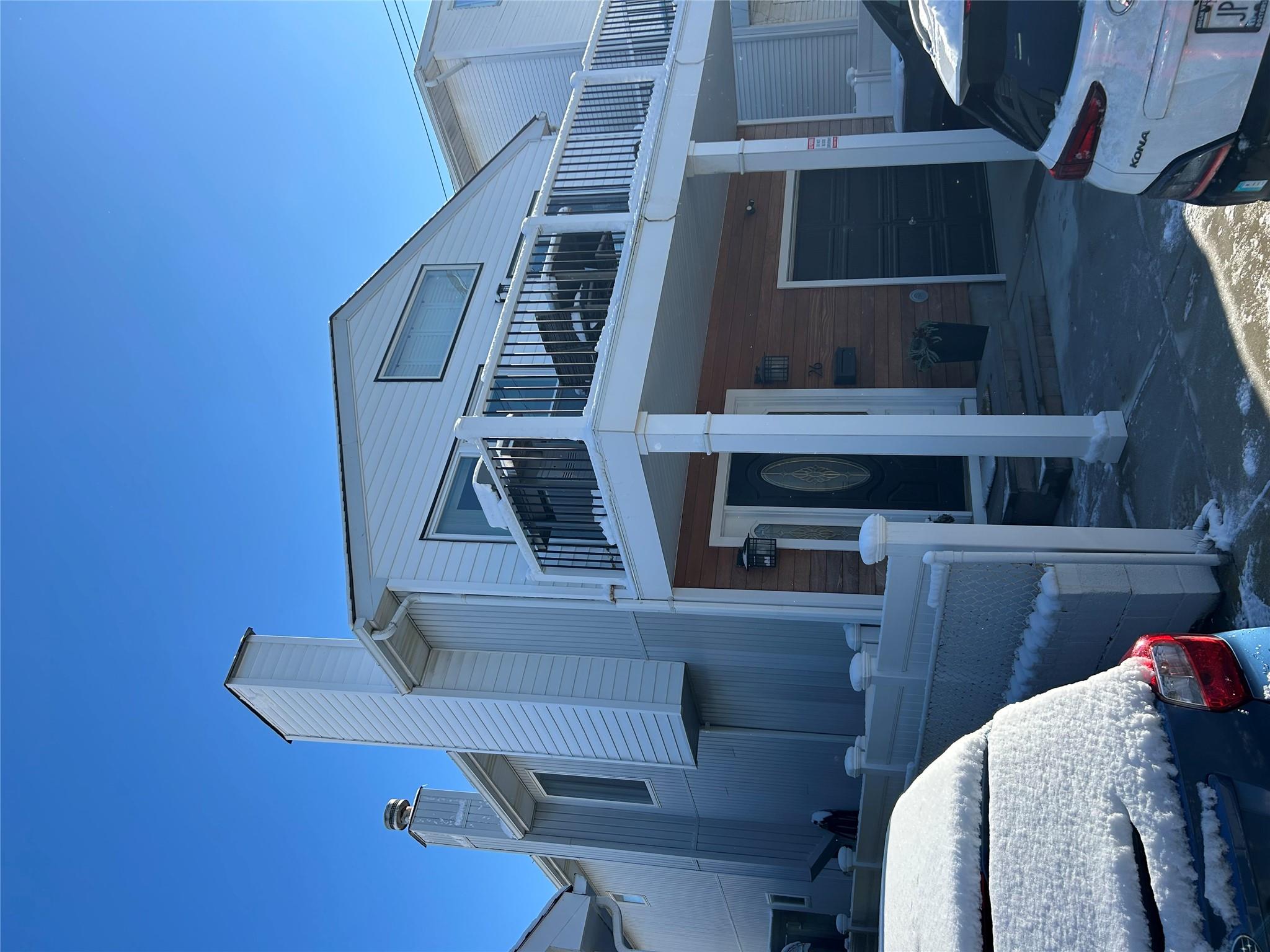 View of front facade with a balcony and a garage