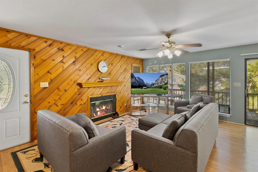 a living room with fireplace furniture and a large window