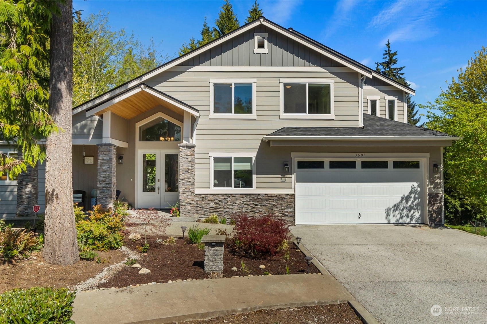 a front view of a house with a yard and garage