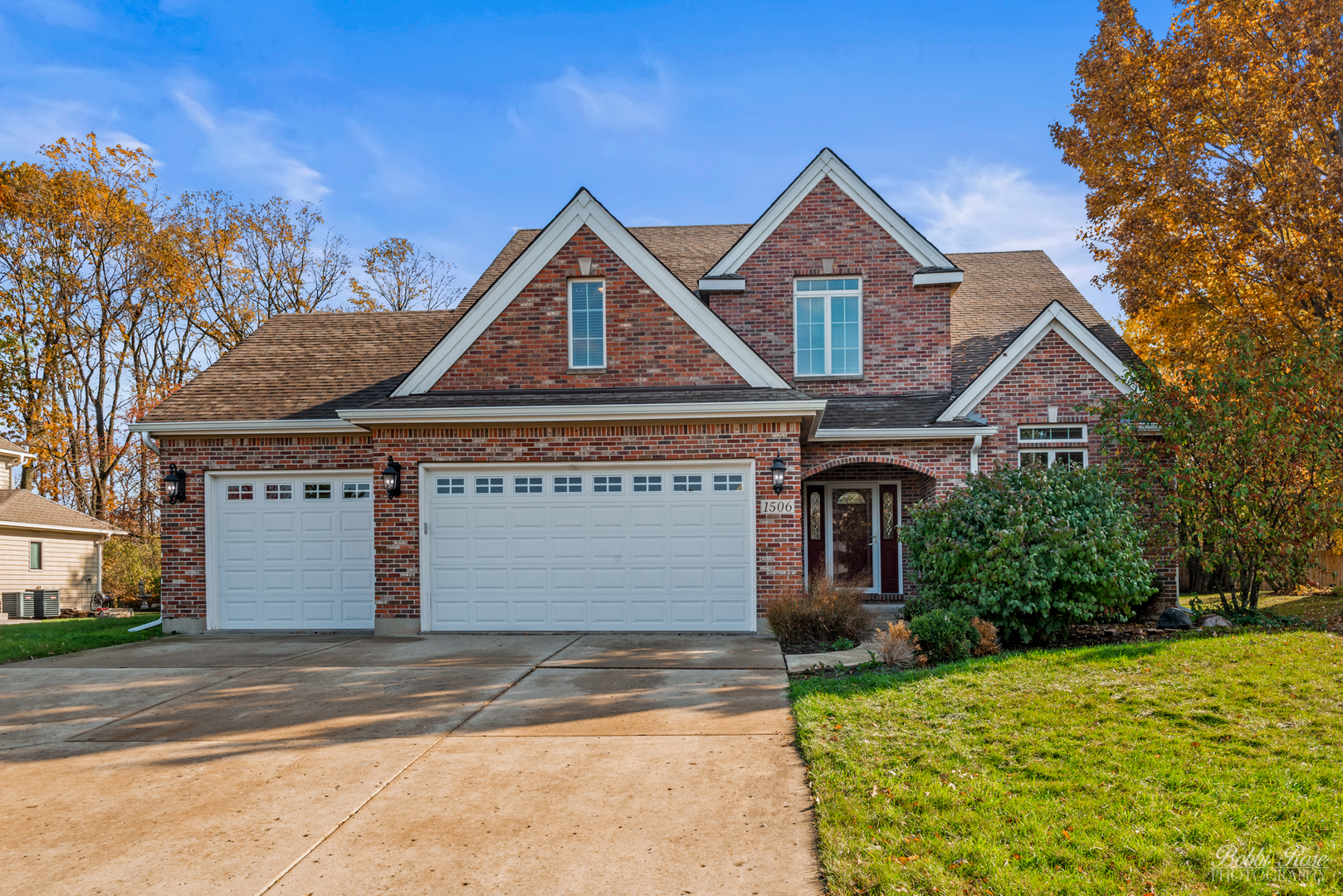 a front view of a house with a yard and garage