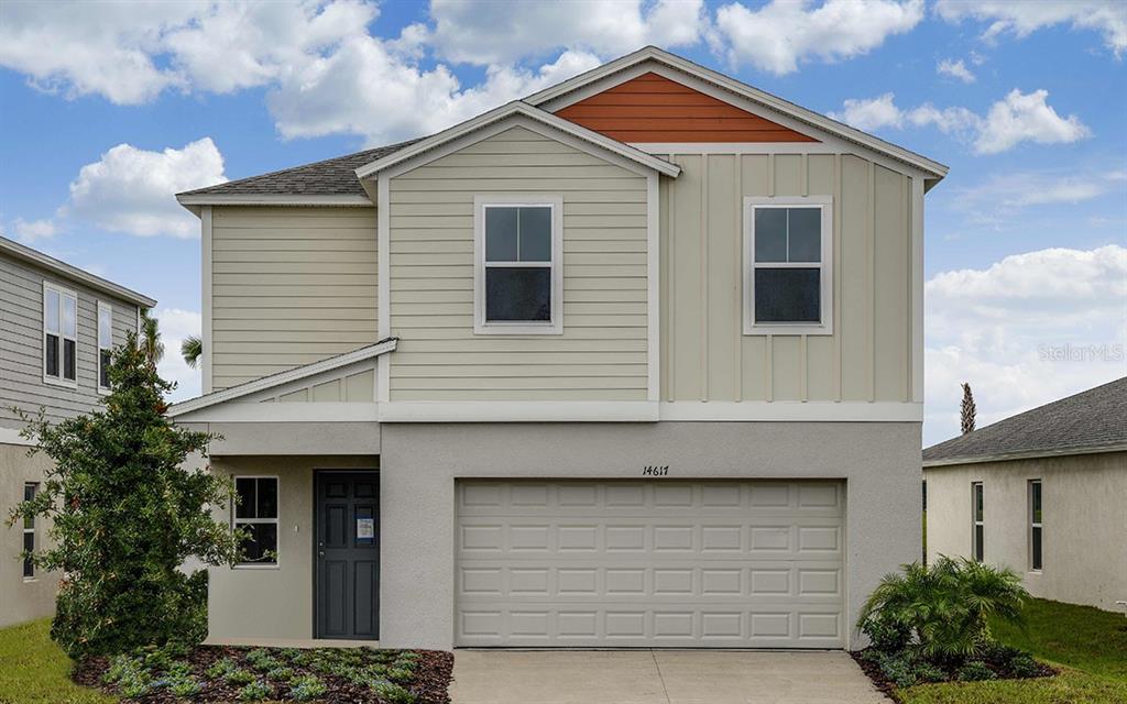 a front view of a house with garage