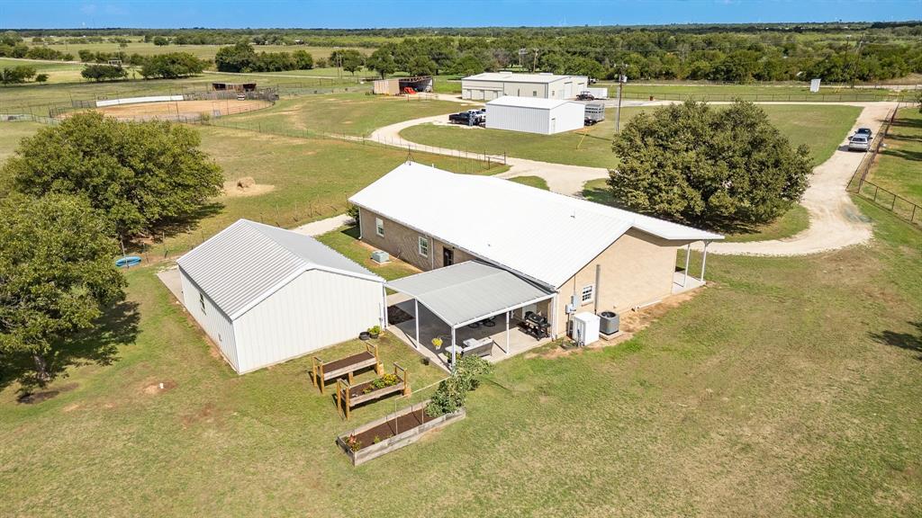 an aerial view of a house with garden space and lake view