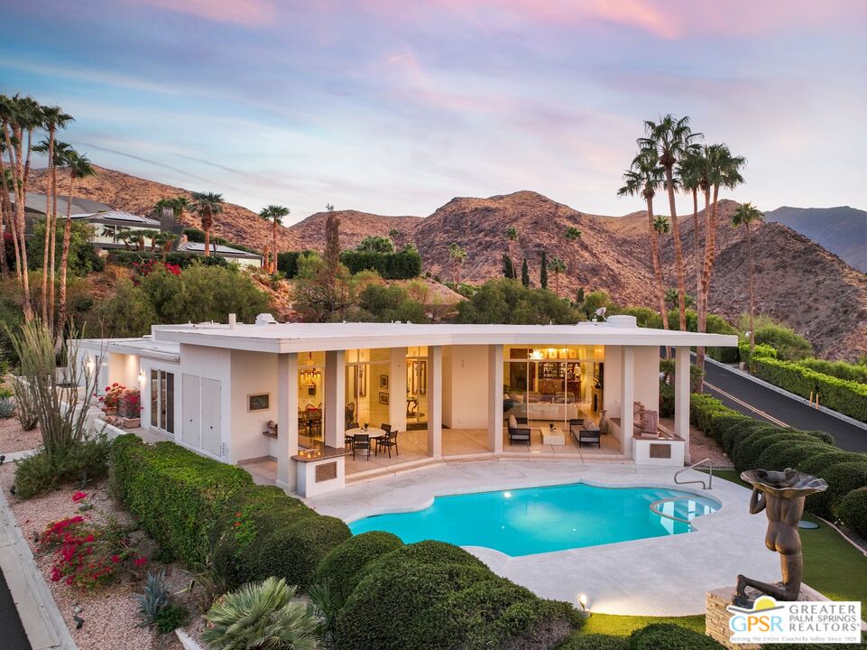 a view of a house with pool and furniture