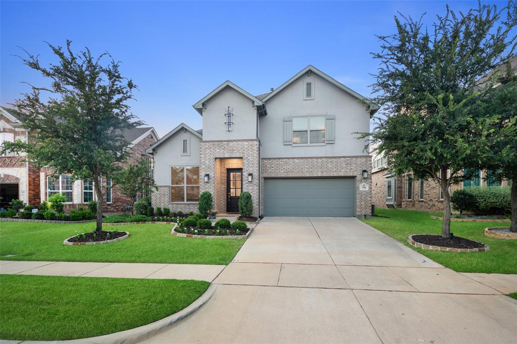 a front view of house with yard and green space