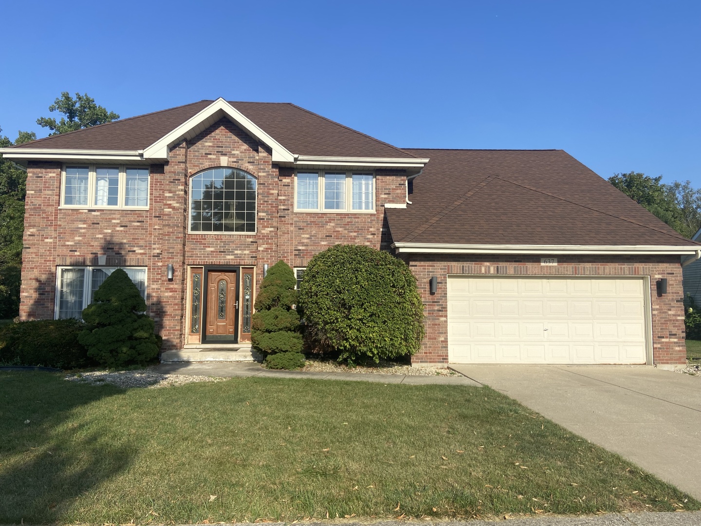 a front view of a house with a yard