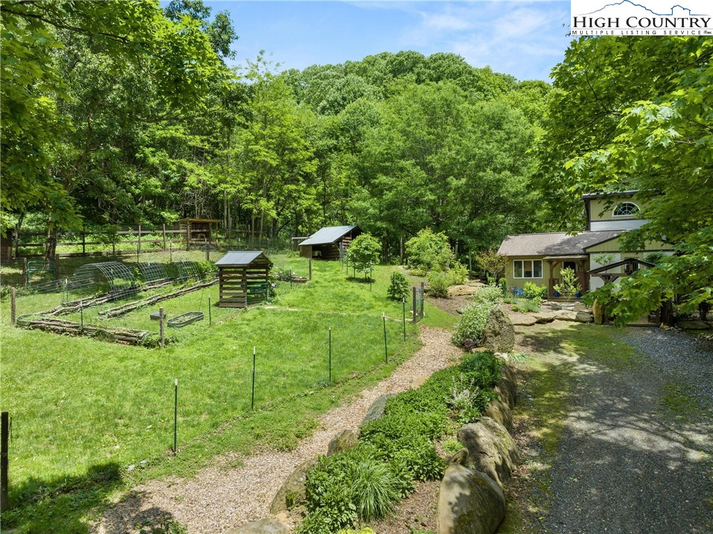 a backyard of a house with a yard and outdoor seating