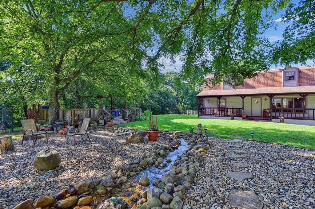 a view of a house with a yard and sitting area