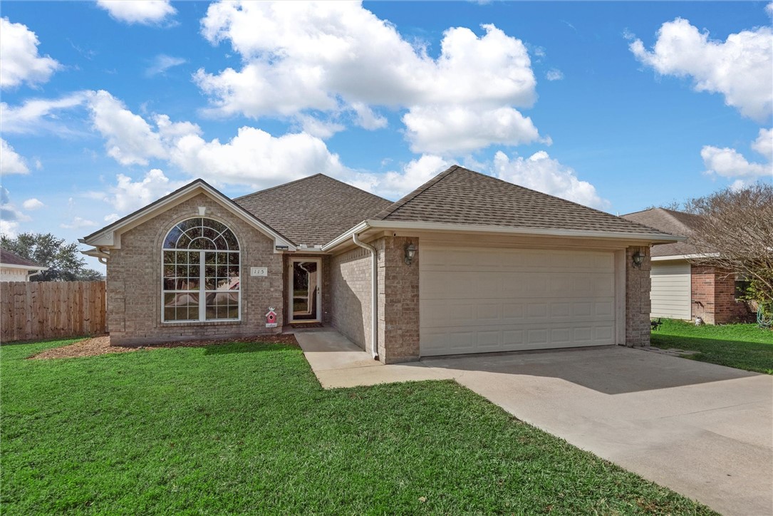 Ranch-style house featuring a front yard and a gar