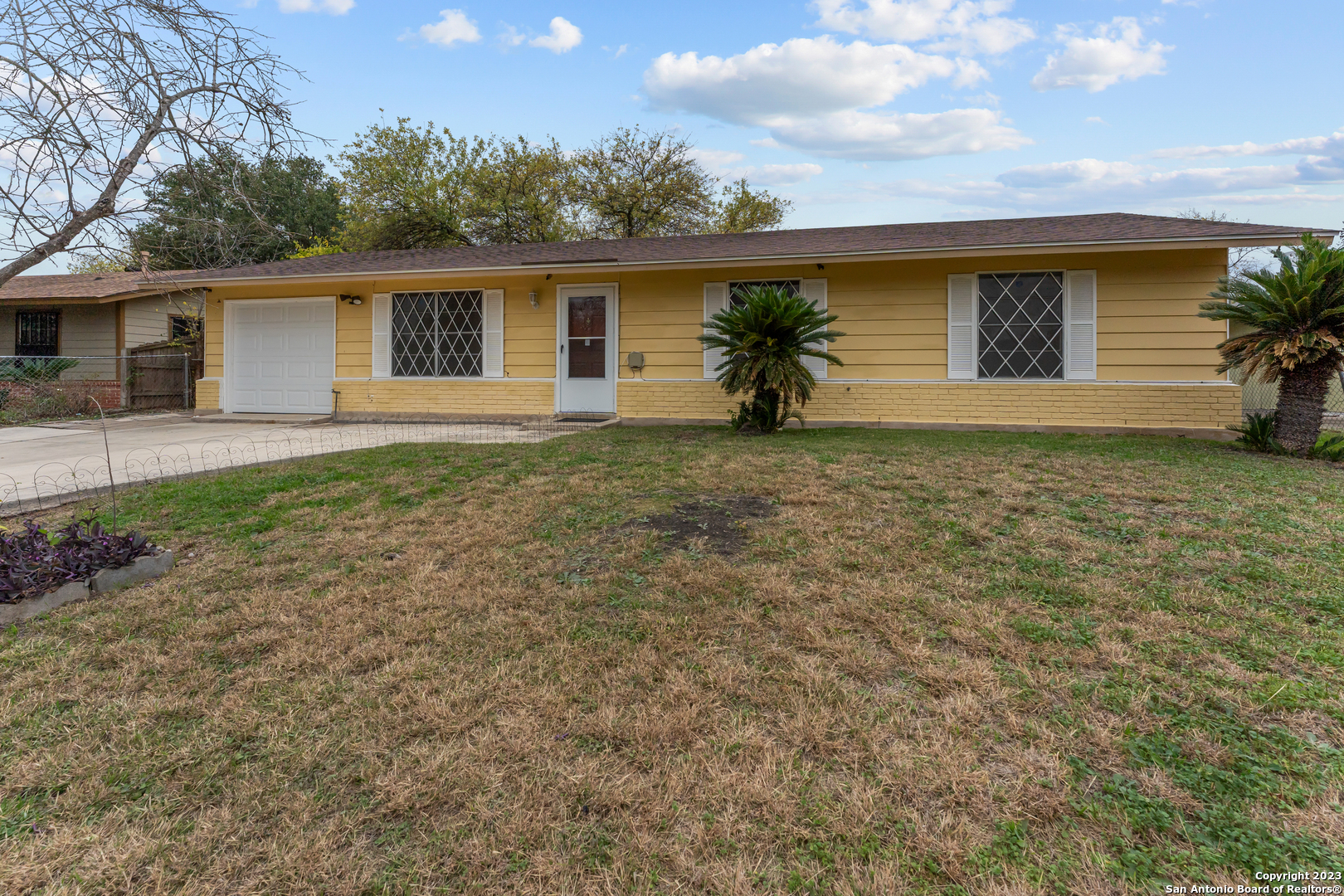 a front view of house with yard and trees