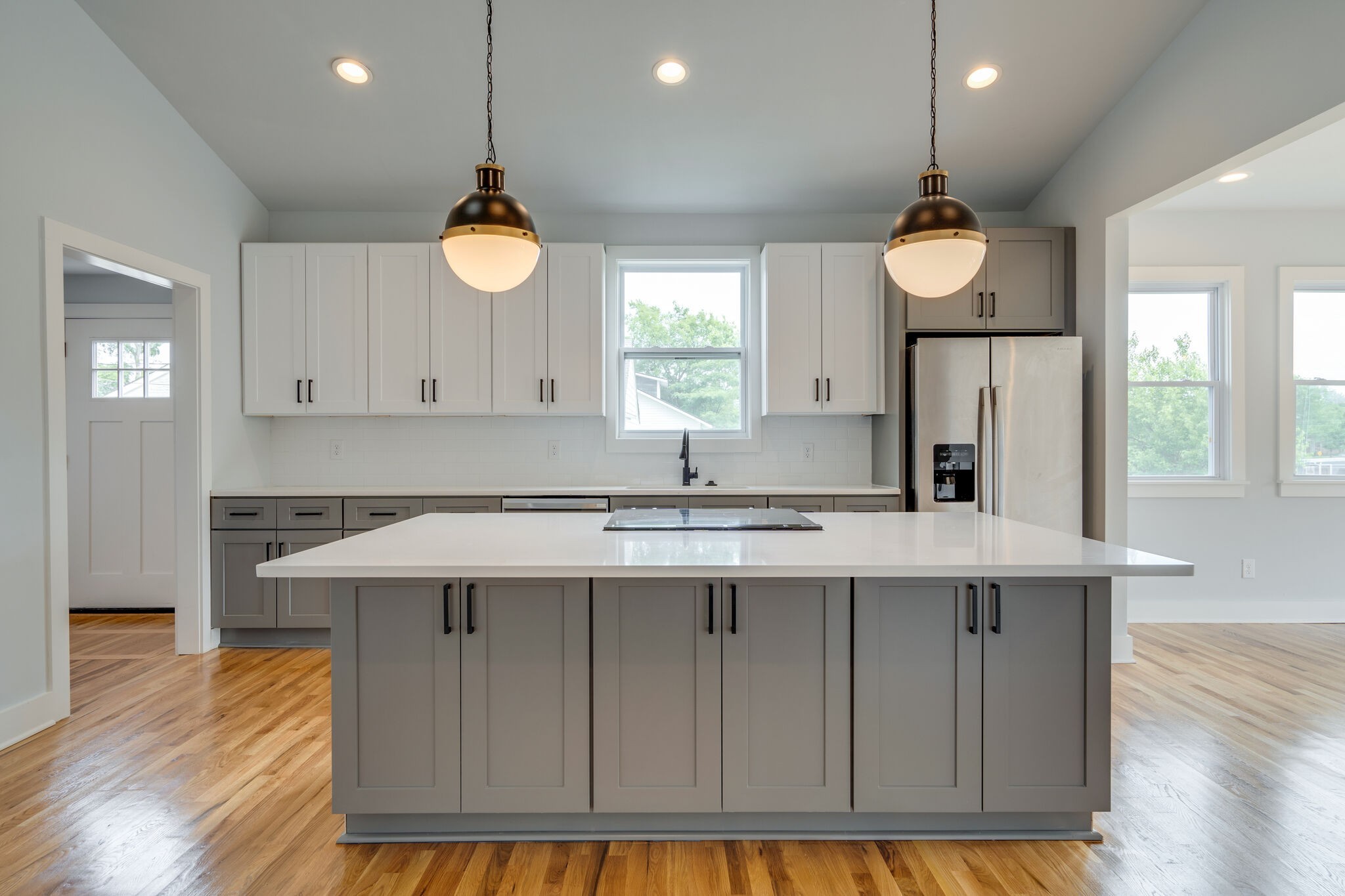 a kitchen with a sink cabinets and wooden floor