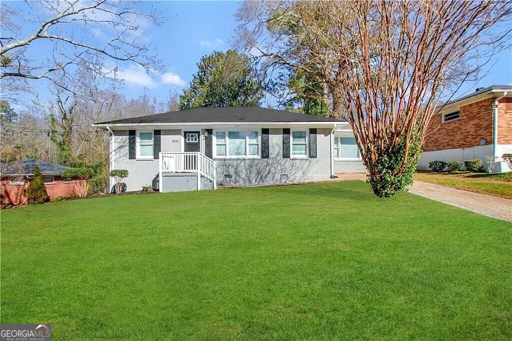 a front view of house with yard and green space