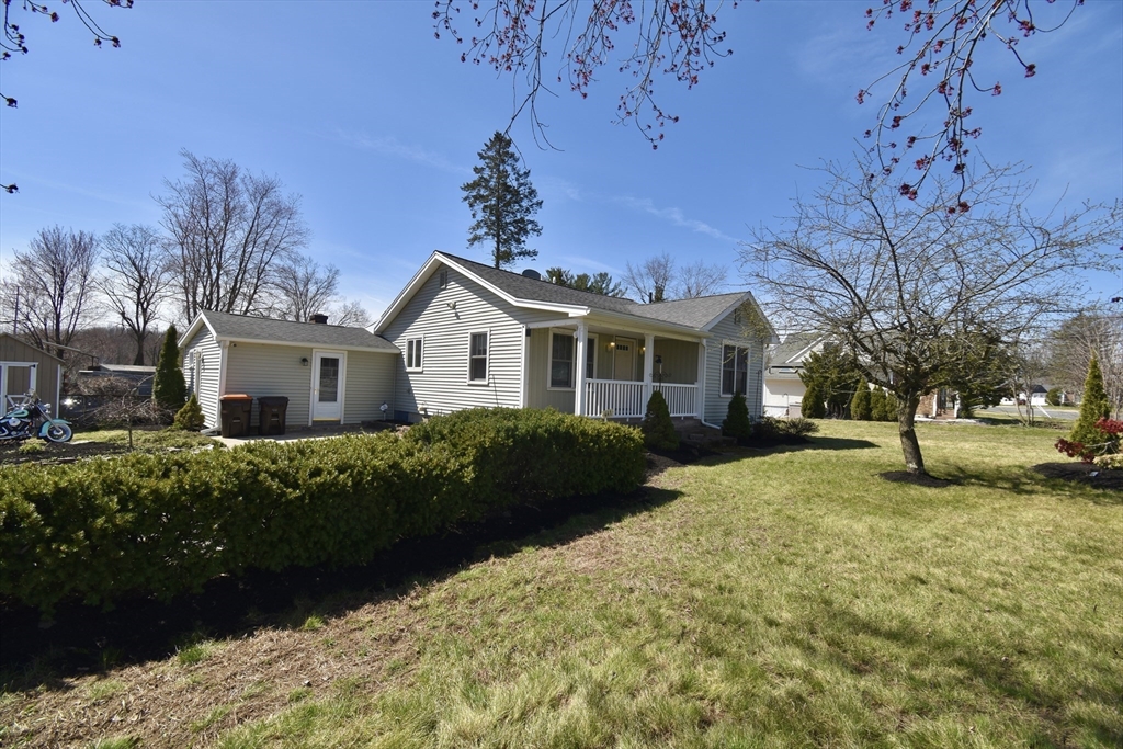 a front view of a house with a garden