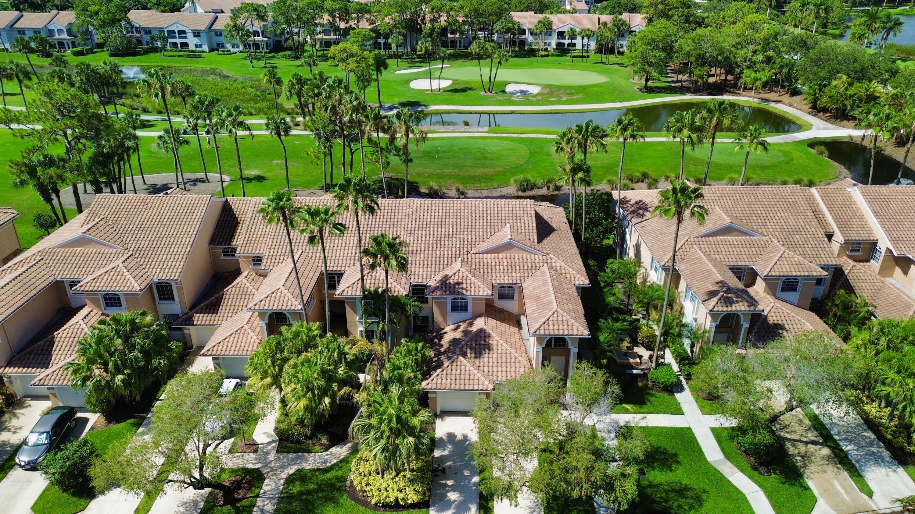 an aerial view of a house with a garden and lake view